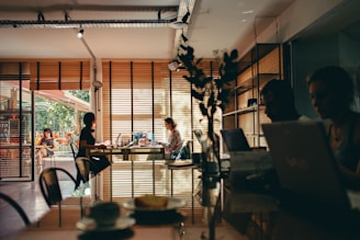 group of people sitting while using laptop computer
