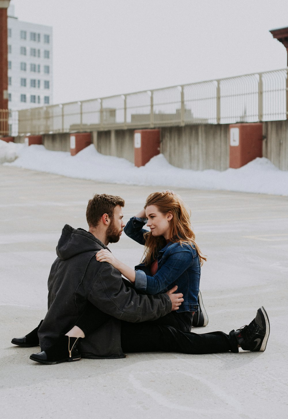 woman sitting on man's lap during daytime