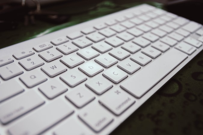 White Apple Magic Keyboard on a clean desk surface