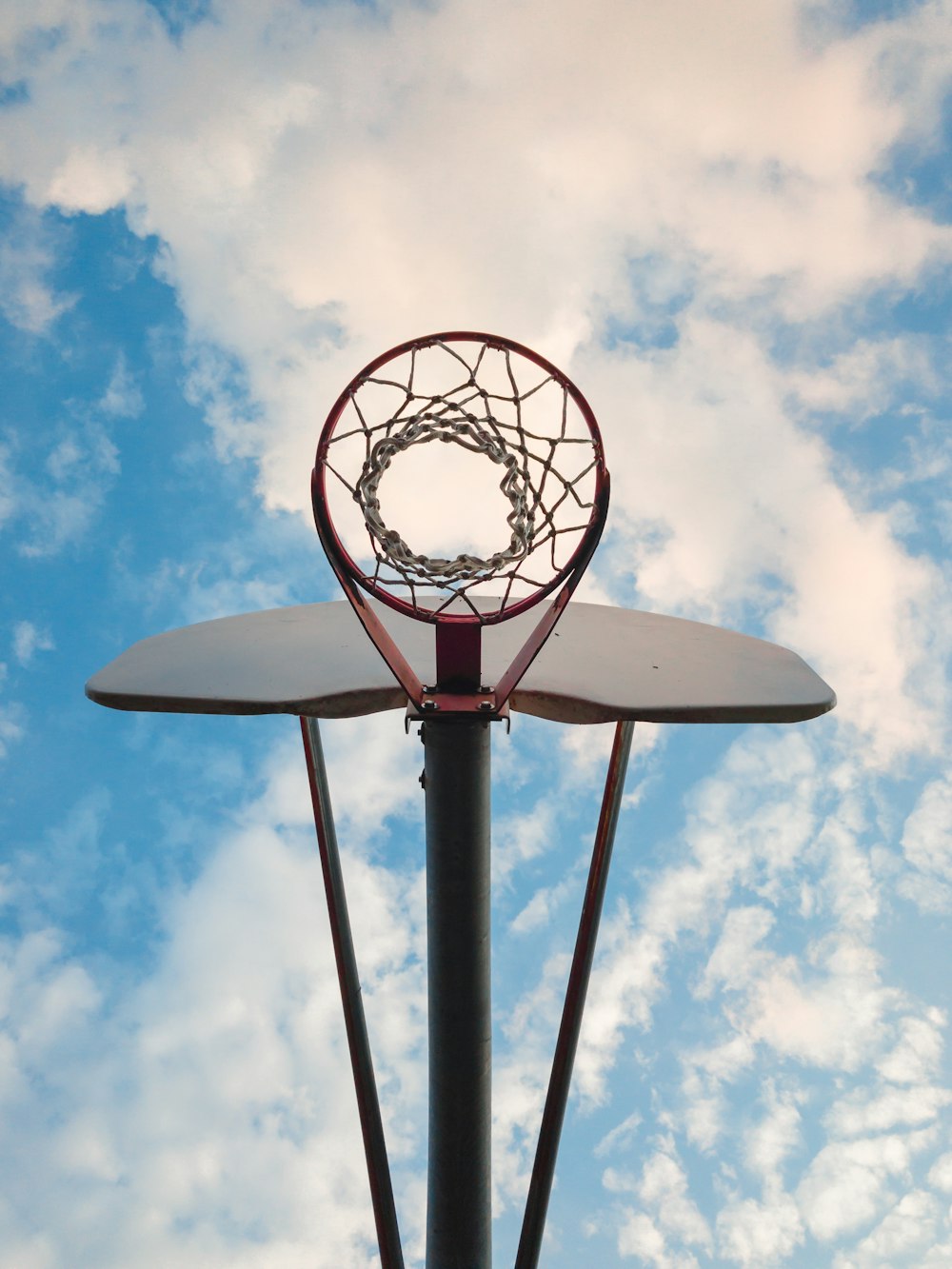 Foto eines rot-weißen Basketballkorbs aus niedrigem Winkel