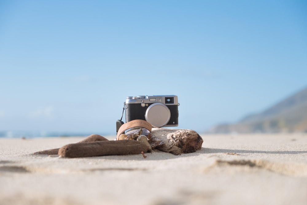 selective focus photography of camera on sand