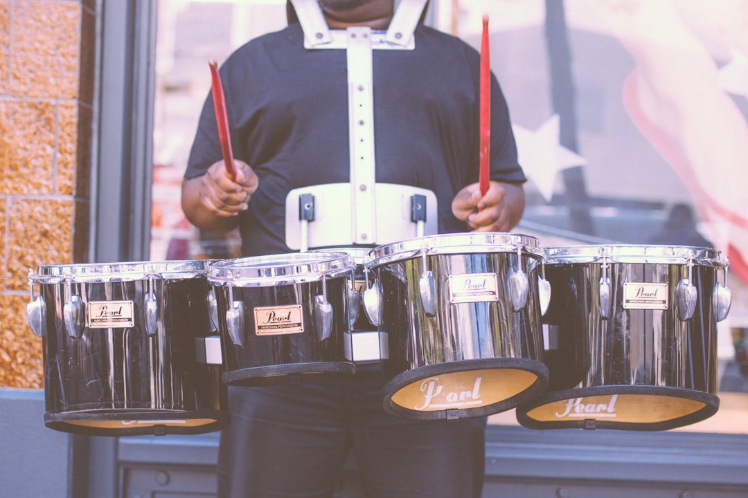 man carrying Pearl drums