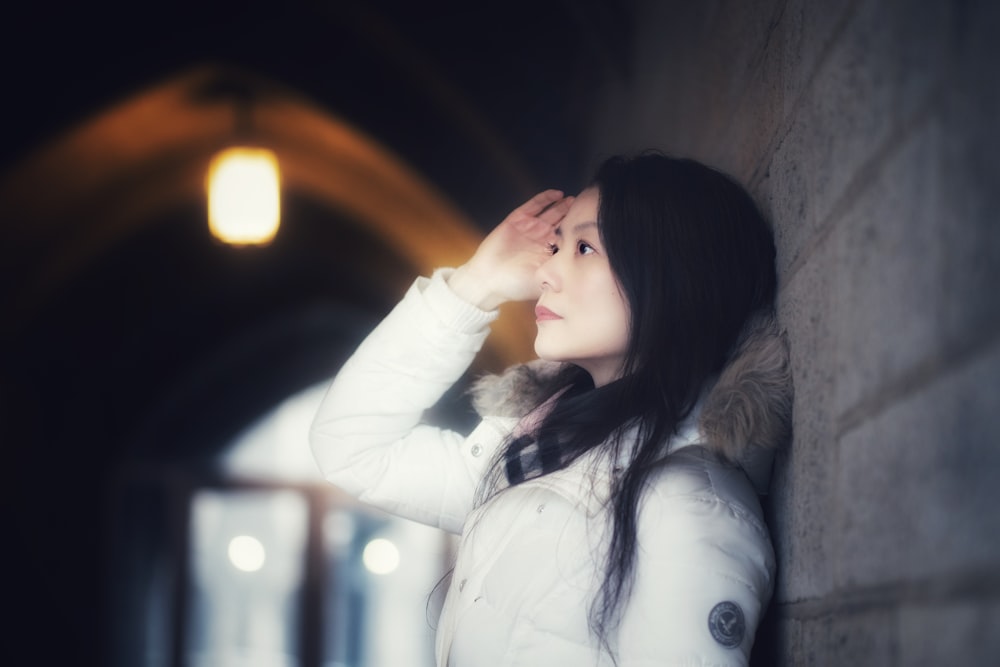 woman leaning on wall