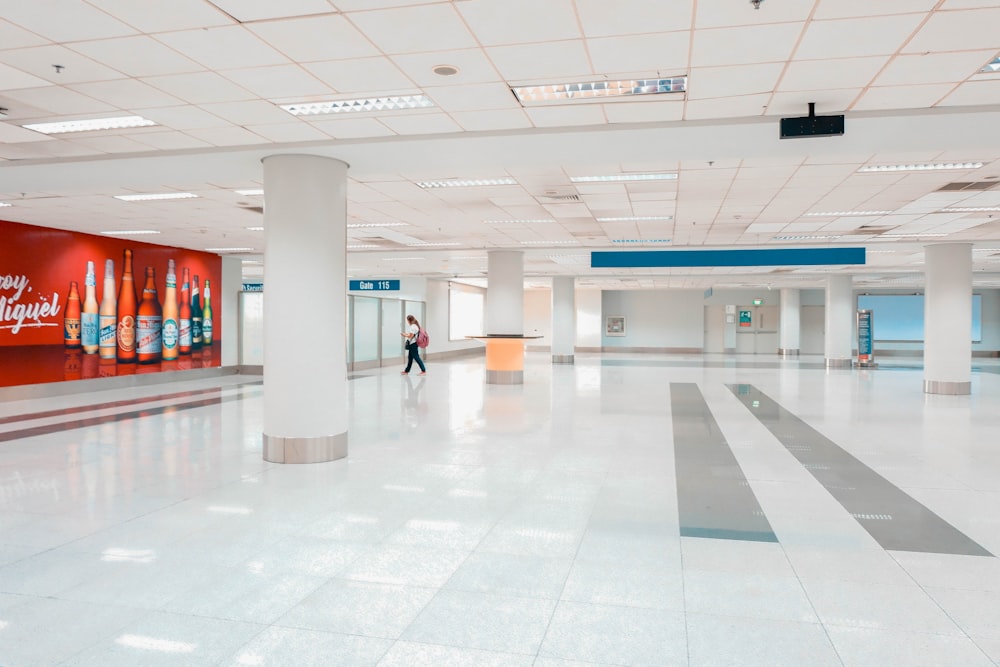 woman walking in white lobby