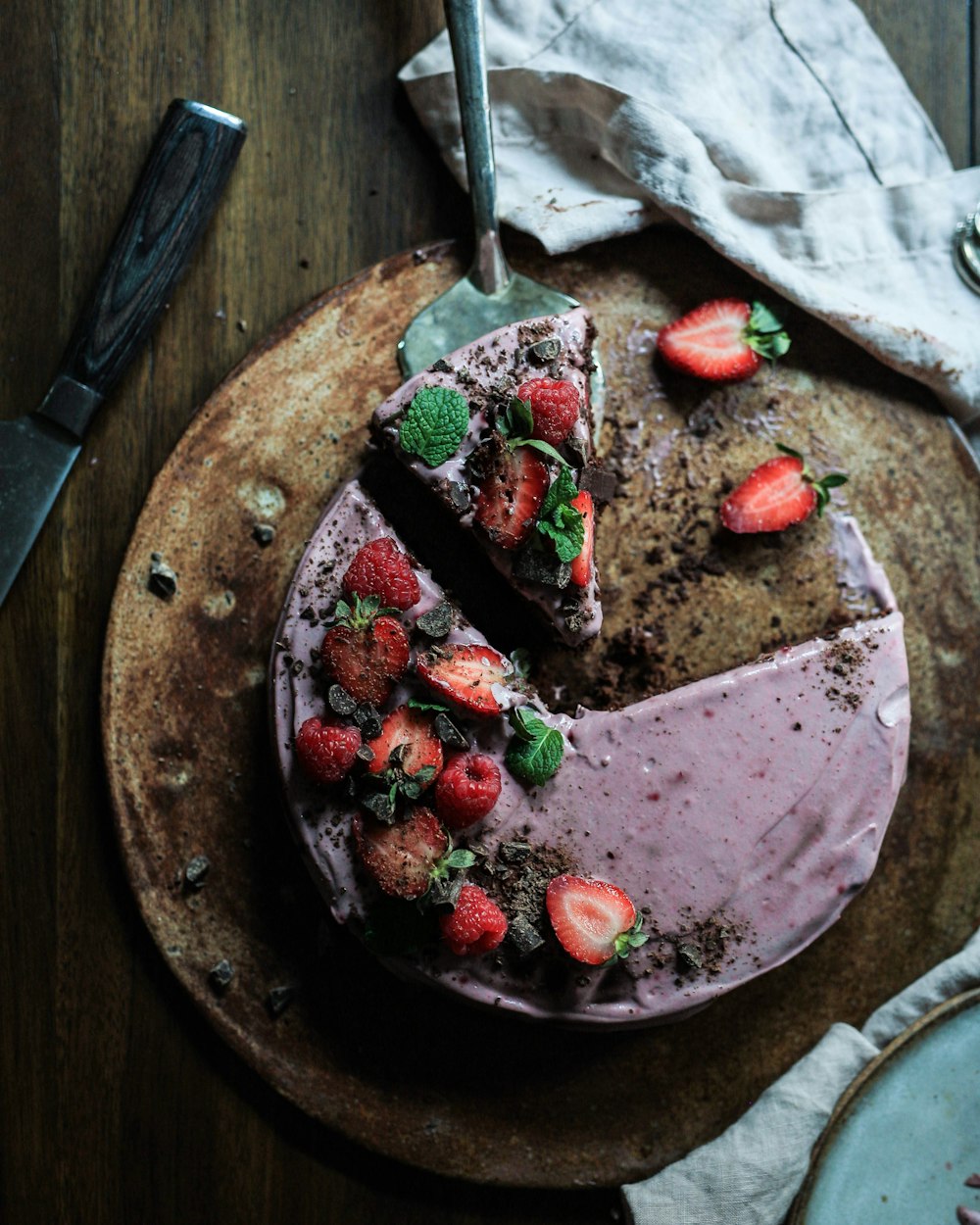 baked cake with sliced strawberries on top