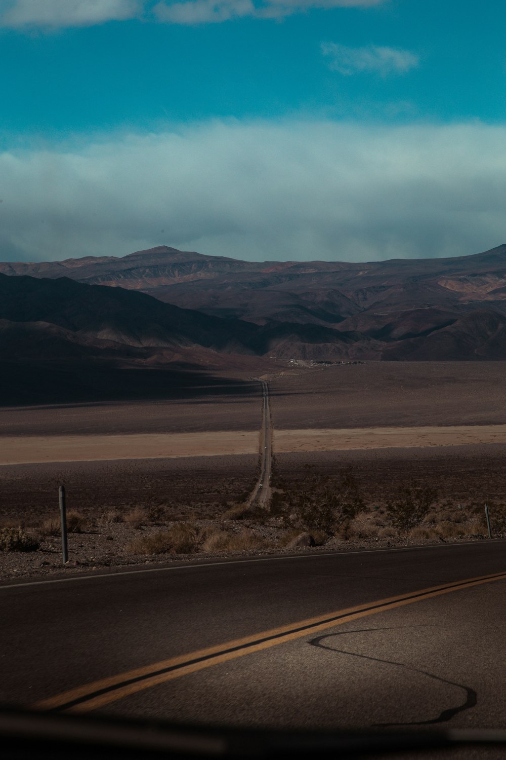 concrete road near hills