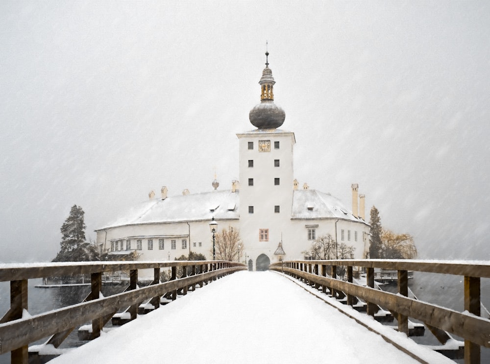 white concrete building near snow covered bridge