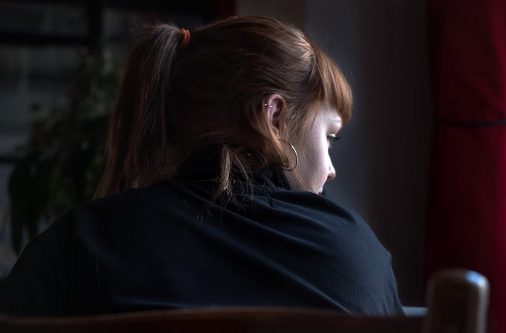 photo of woman sitting on chair