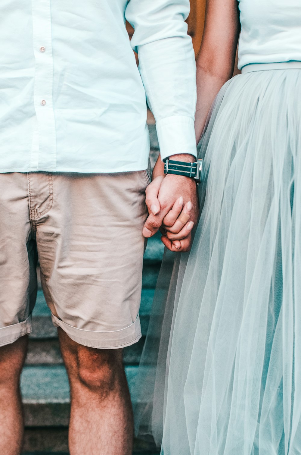 man and woman holding hands while standing