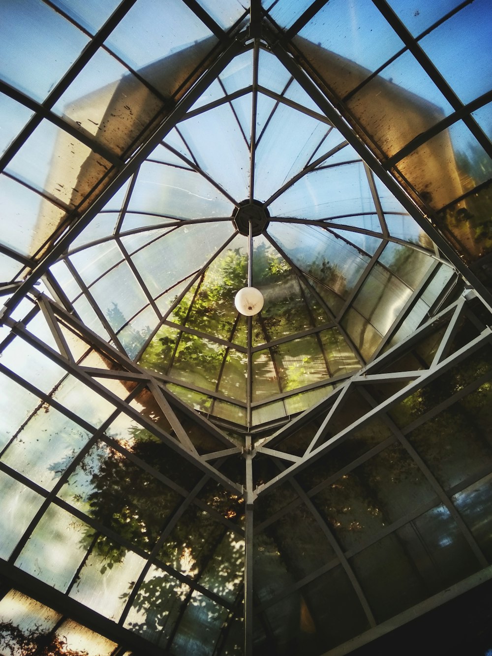 low angle view photography of pendant lamp and glass ceiling