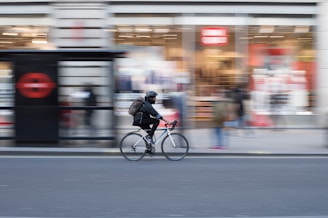 time lapse photo of person riding on white road bicycle