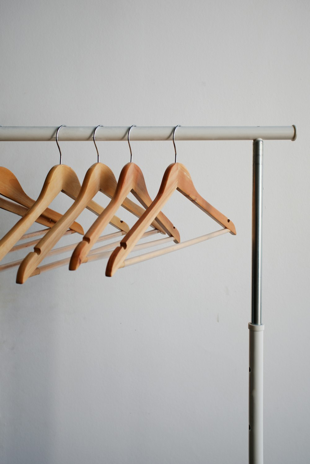 four brown wooden clothes hangers