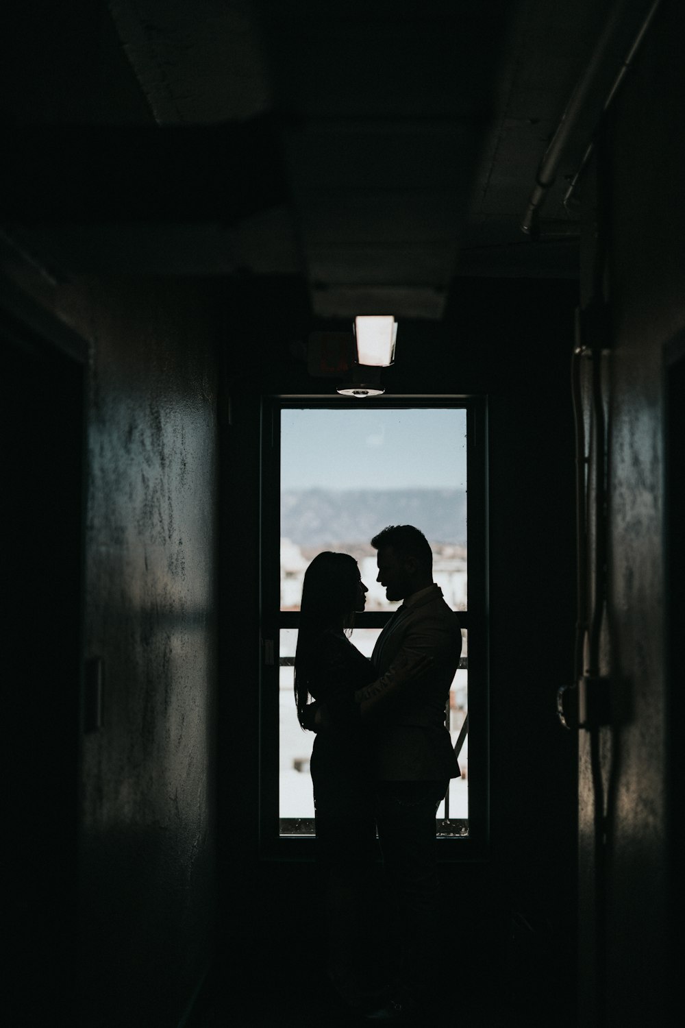 silhouette of couple inside dark room