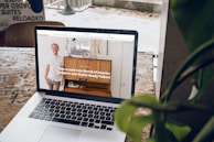 MacBook Pro on top of brown wooden table during daytime