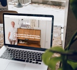 MacBook Pro on top of brown wooden table during daytime