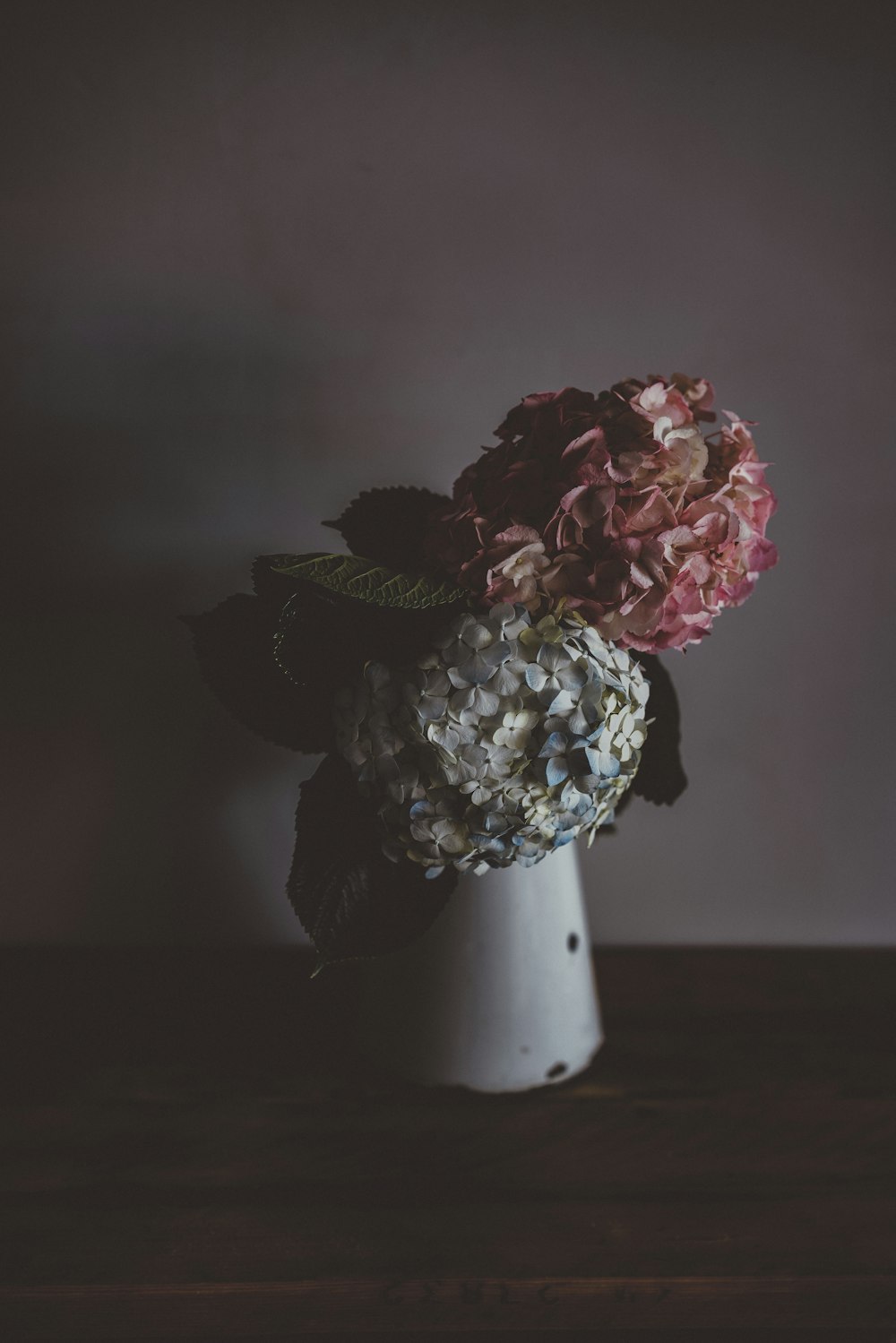 flores cinzas e cor-de-rosa no vaso branco