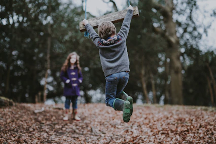 boy holding onto swing after chiropractic care