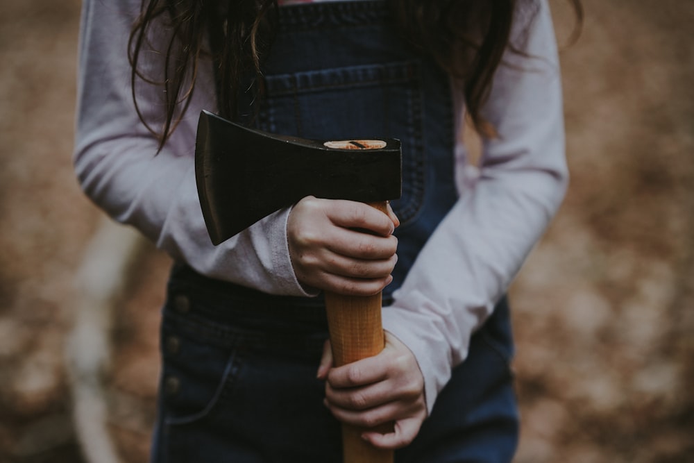 a woman holding an axe in her hands