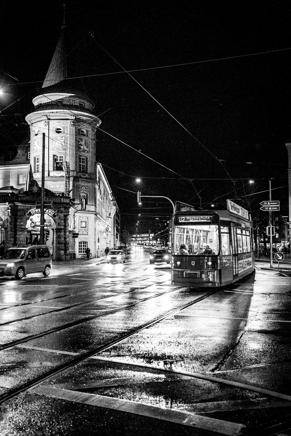 grayscale photography of tram near building
