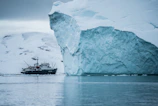 A majestic iceberg floating silently in the chilly polar waters, viewed from the ship.