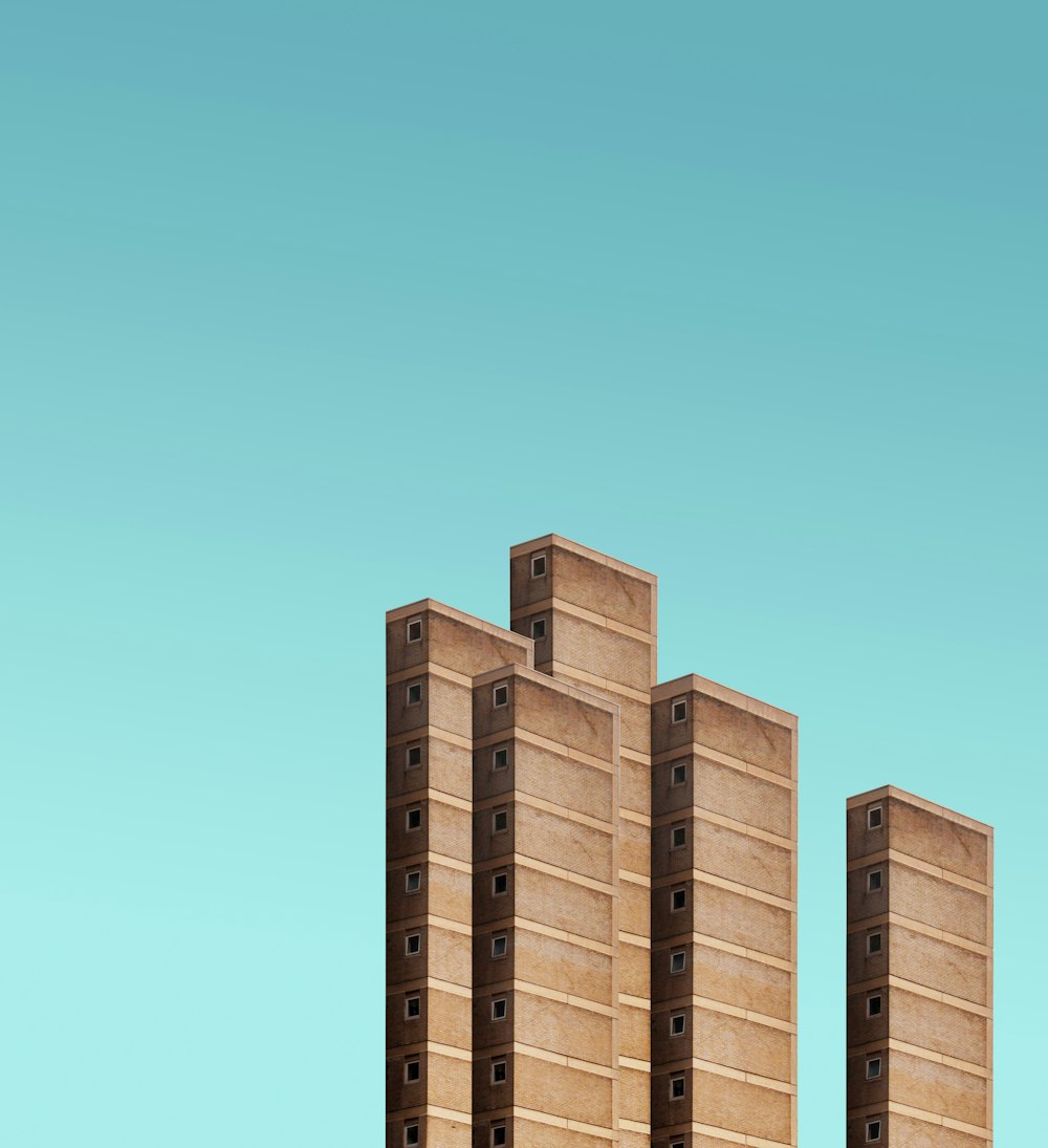 five brown high rise buildings