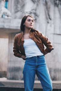 woman standing near gray wall during daytime