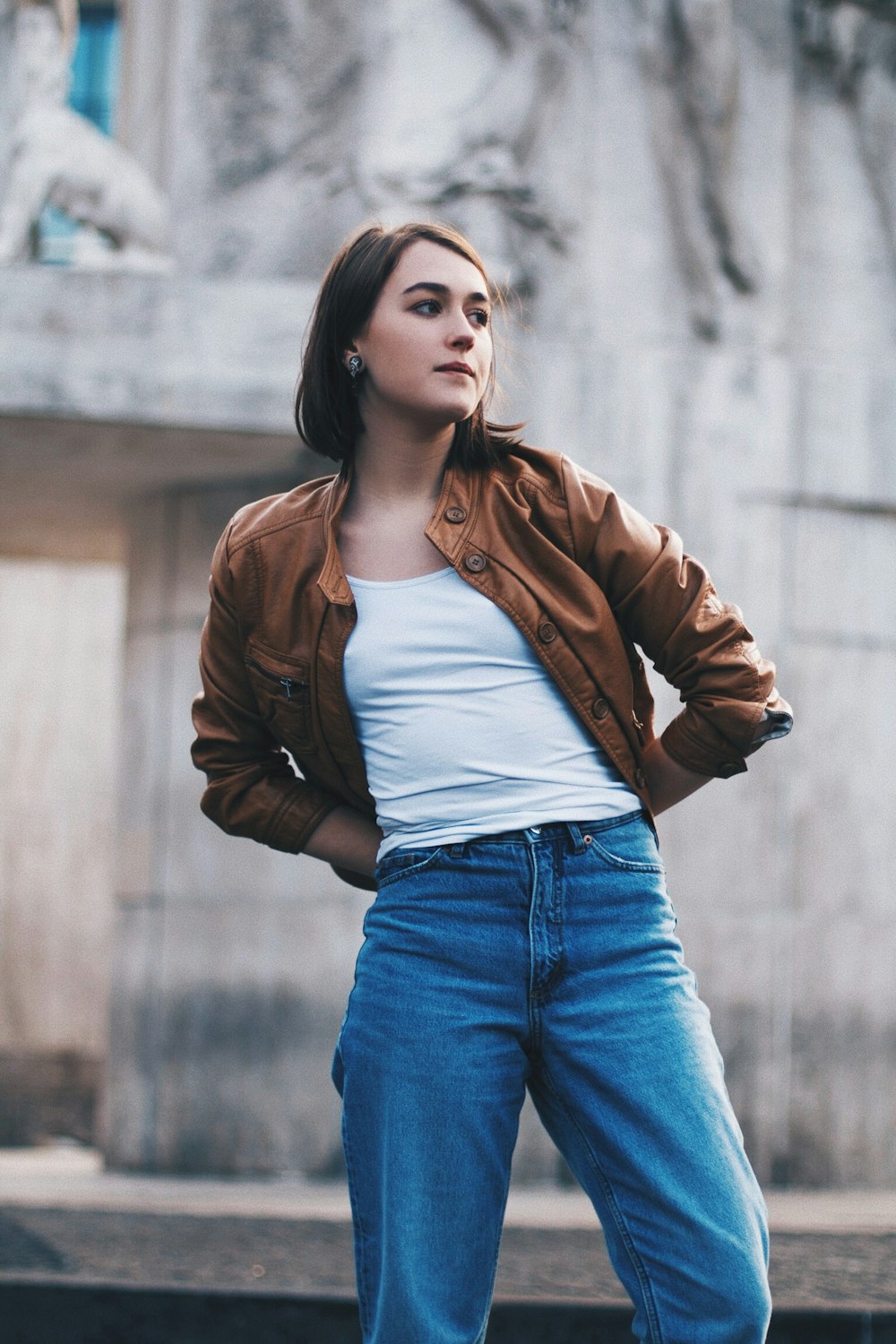 woman standing near gray wall during daytime