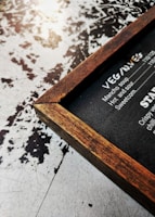 Elegant wooden menu holders standing on a rustic table, showcasing simple, clean lines and natural textures.