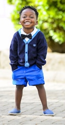 selective focus photo of boy standing on grey pavement