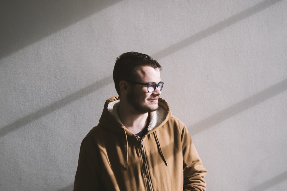 smiling man standing near wall during daytime