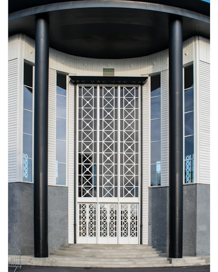 A sleek, modern corporate building entrance with black and gold accents symbolizing security and professionalism.