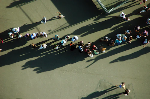 Long queue of travelers with luggage at an airport check-in counter