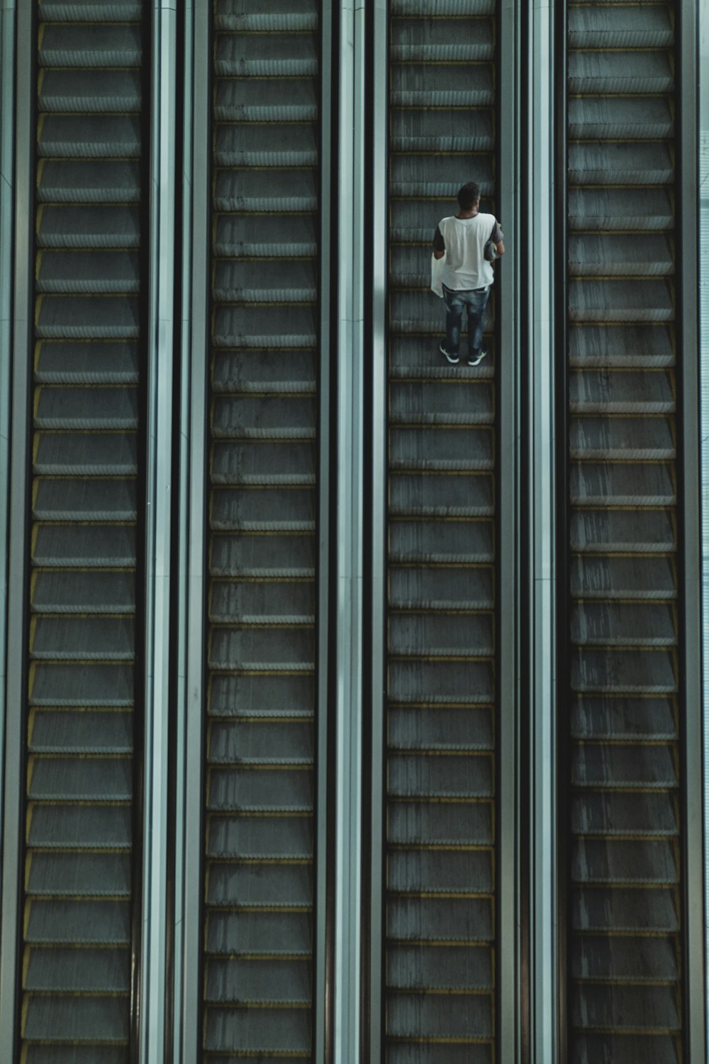 man riding on escalator