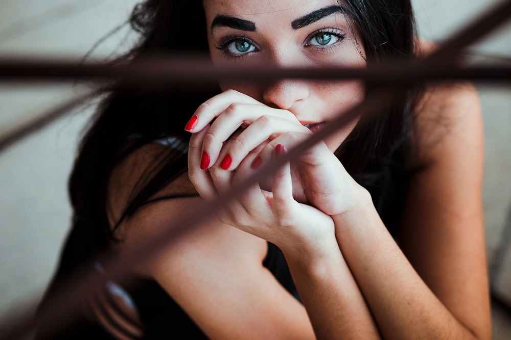 selective focus photography of woman sitting on ground