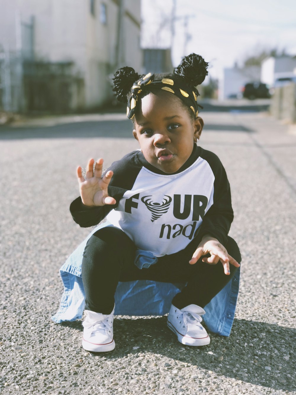 girl sitting on gray concrete road