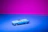 Close-up of a satisfied customer holding a custom 3D printed car accessory with a neon blue background.