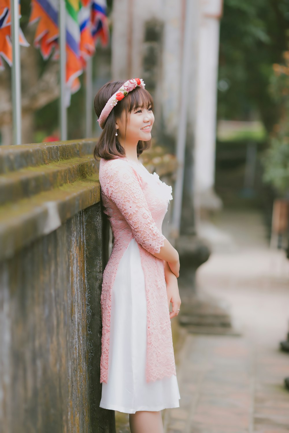 smiling woman in pink floral dress