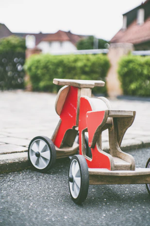 Close-up of colorful outdoor ride-on toys lined up on a sunny garden lawn.