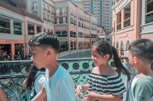 Children crossing a newly built modular bridge with smiles and backpacks.