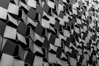 Abstract road graphics in silver and black forming dynamic geometric patterns.