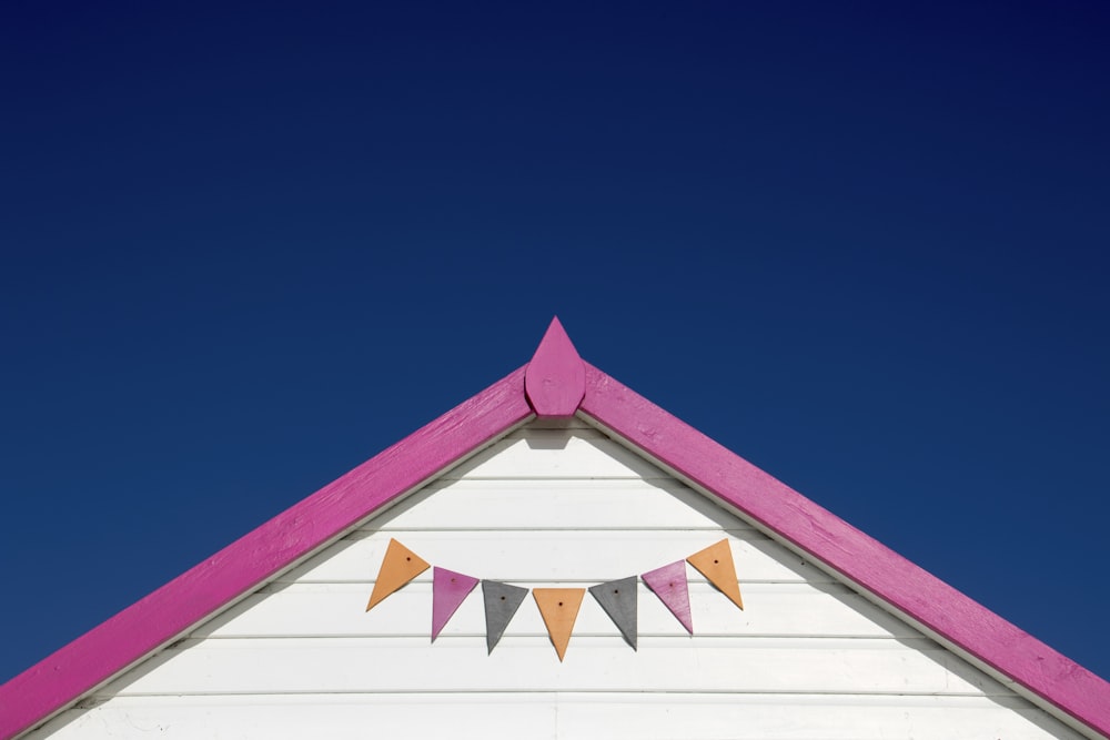 white and pink wooden house roof