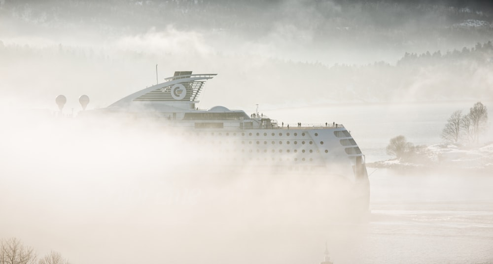 white cruise ship covered in mist