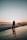 silhouette photo of couple standing on beach watching sunset