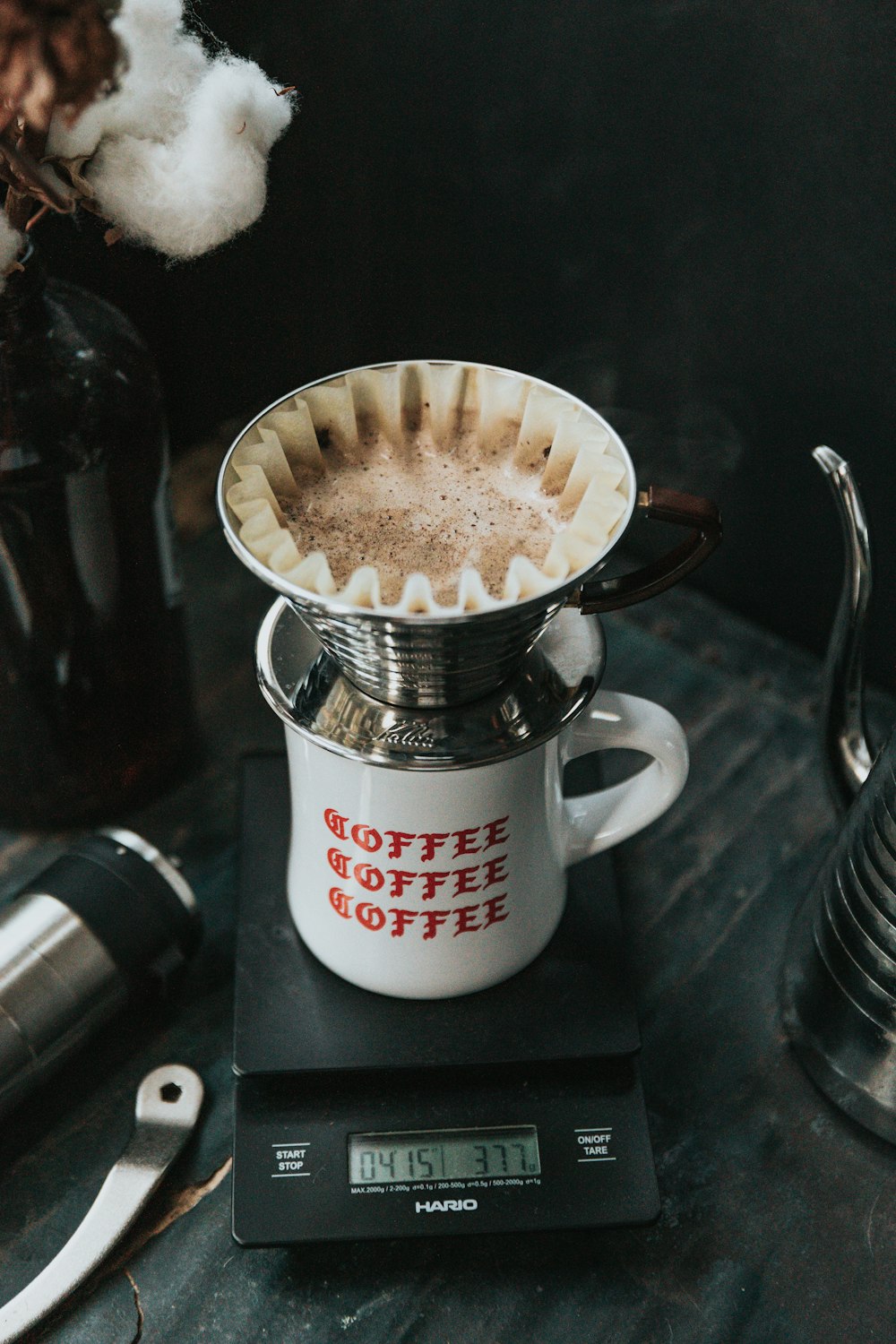 white ceramic mug on black pocket scale