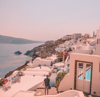 A cozy Cypriot seaside village with sunlit white houses and blooming bougainvillea.