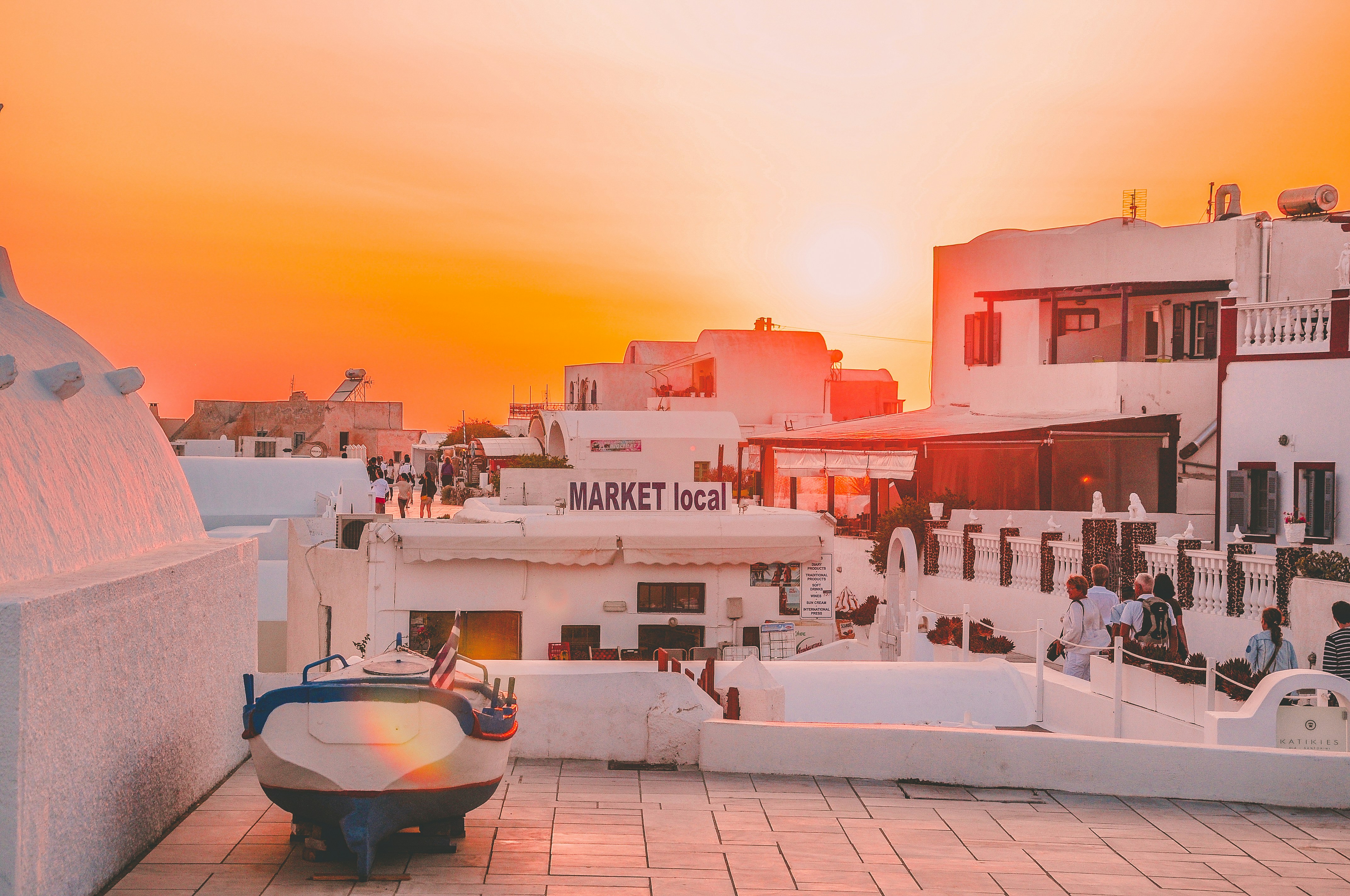 landscape photo of people walking on road during golden hour