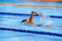 person swimming on an olympic pool