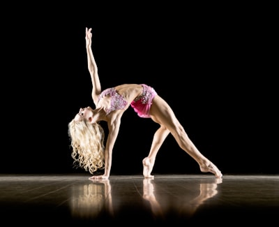 woman bending on floor and with black background movement zoom background