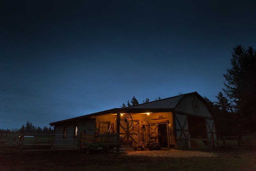 photo of brown house near tree during night time