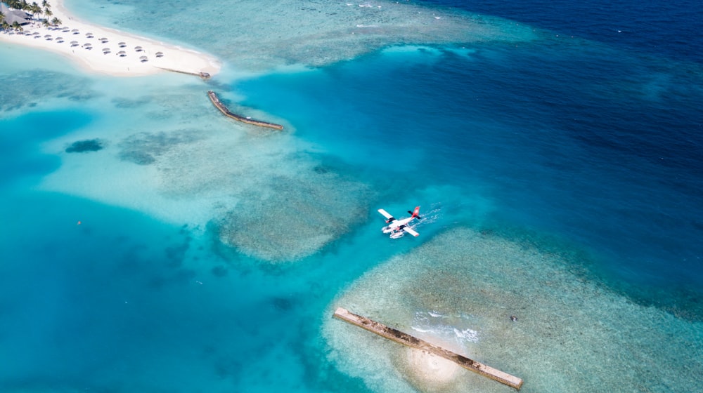 top view of white plane on body of water